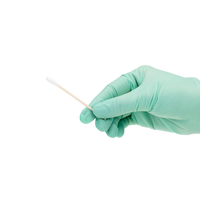 Gloved hand holding sample of cotton tip applicator