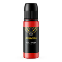 A bottle of Quantum Tattoo Ink in the 'Kick A Ginger' a 'Scarlet Red' color. The bottle has a black ribbed cap, a black label with gold geometric line art and text, and a red translucent plastic body showing the liquid inside.