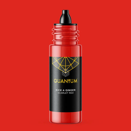 Quantum Tattoo Ink - Kick a Ginger a Scarlet red color with black dropper top featuring a black label with a yellow geometric logo and text, set against a solid red background.