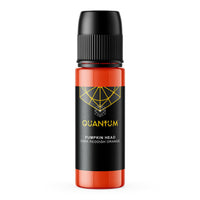 A bottle of Quantum Ink in the 'Pumpkin Head' , which is a dark reddish orange color. The bottle is semi-transparent, showing the orange liquid inside, with a black label featuring a yellow geometric logo and text, and a black cap on a white background
