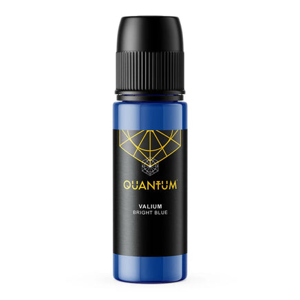A bottle of Quantum Tattoo Ink - Valium Bright Blue color with a black cap and a black label featuring a gold geometric logo and text, set against a plain white background.