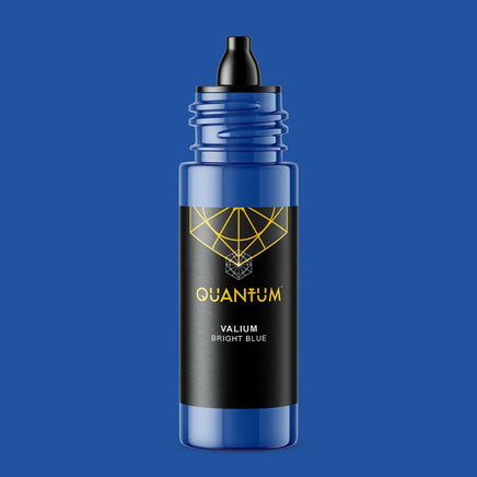 Quantum Tattoo Ink - Valium - Bright Blue color, featuring a translucent blue bottle with a black label and a black dropper cap, set against a solid blue background.