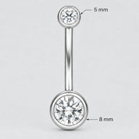 A silver-toned navel piercing barbell stud with a clear round gemstone in the bottom ball, AND A GEMSTONE  IN THE TOP BALL shown on a plain white background.